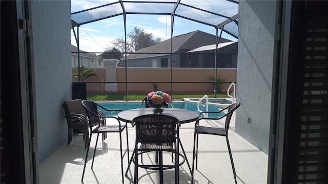 view of patio / terrace with glass enclosure and a fenced in pool