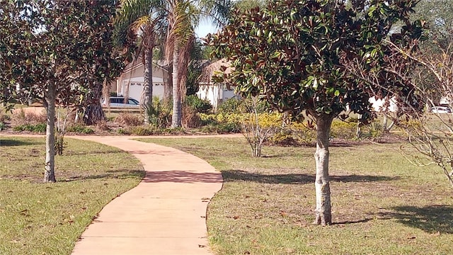 view of home's community with a yard