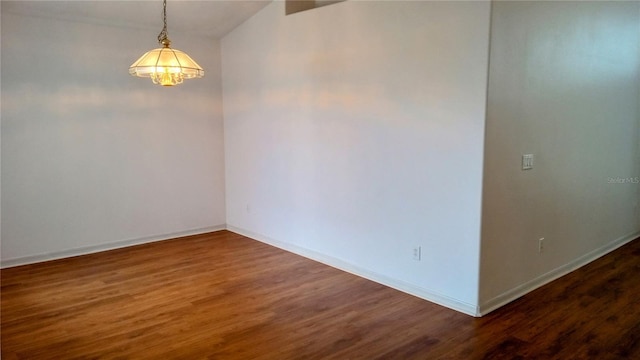 empty room featuring dark wood-type flooring