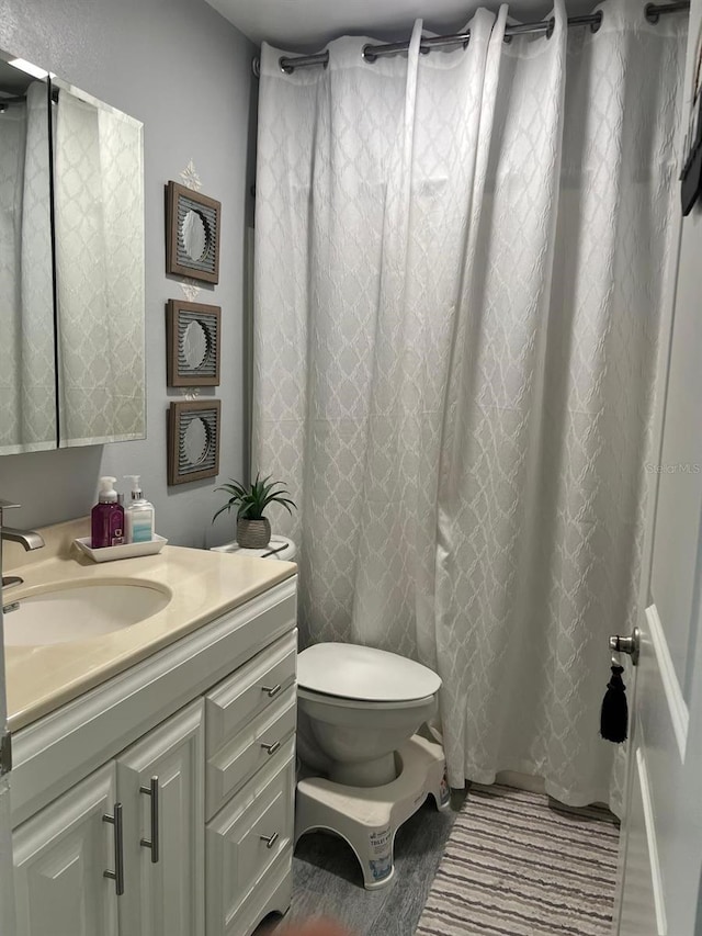 bathroom featuring vanity and toilet