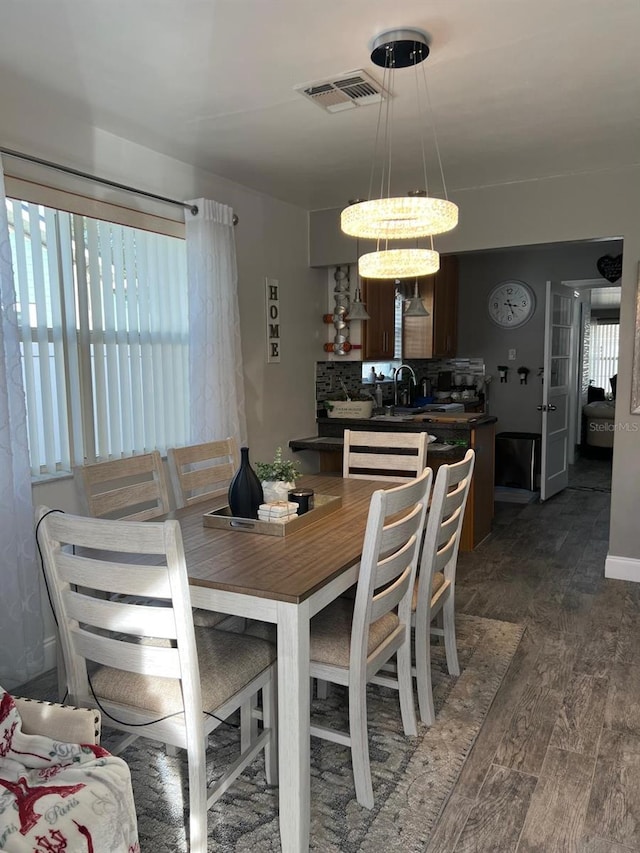 dining room featuring dark hardwood / wood-style floors and sink