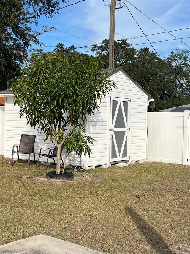 view of outbuilding featuring a lawn