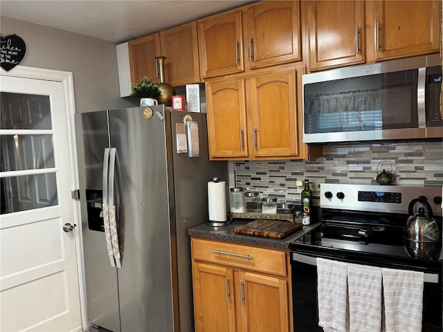 kitchen featuring stainless steel appliances and tasteful backsplash