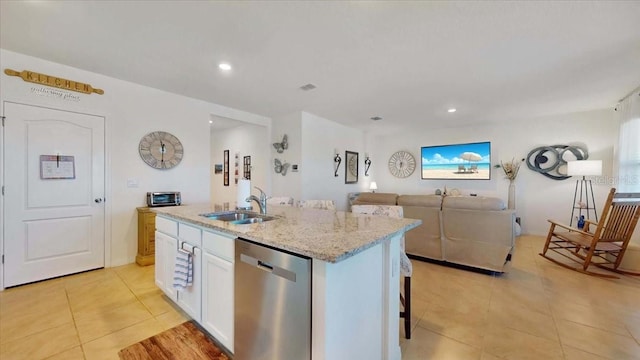 kitchen featuring dishwasher, a center island with sink, white cabinets, sink, and light tile patterned floors