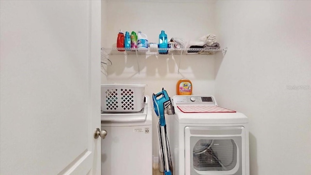 clothes washing area featuring washer and dryer