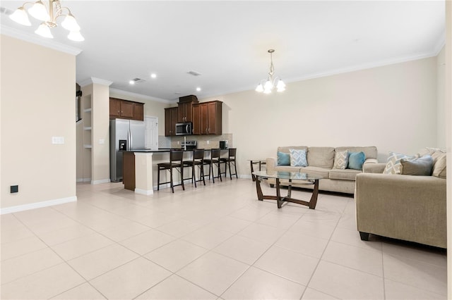 living room featuring light tile patterned flooring, ornamental molding, and a chandelier