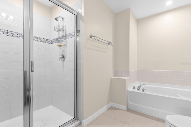 bathroom featuring toilet, shower with separate bathtub, and tile patterned floors