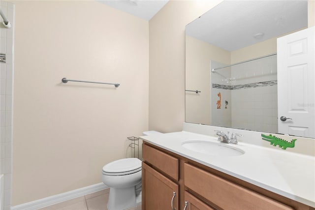 bathroom featuring tiled shower, tile patterned flooring, vanity, and toilet