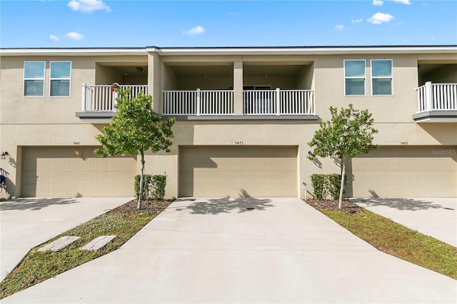 view of property featuring a balcony and a garage