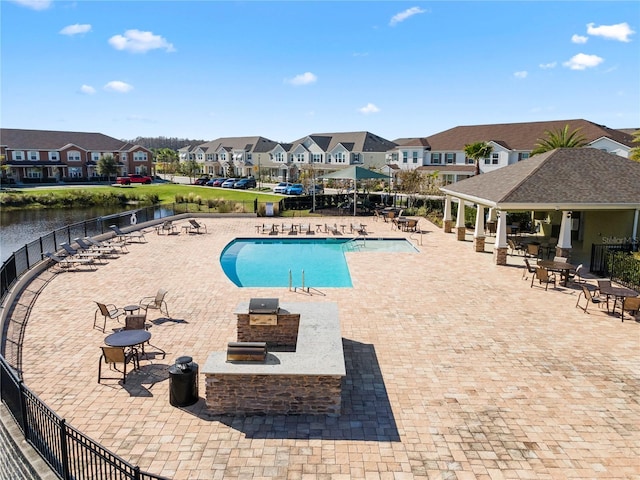 view of swimming pool featuring a gazebo, a patio area, and a water view