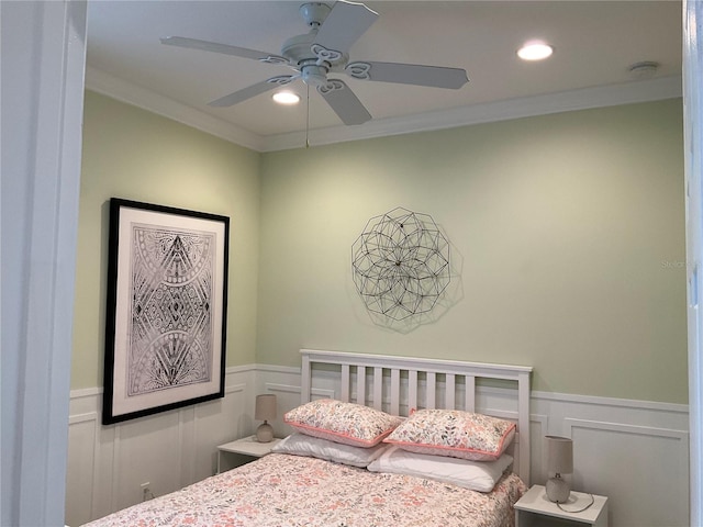 bedroom featuring a nursery area, ceiling fan, and crown molding