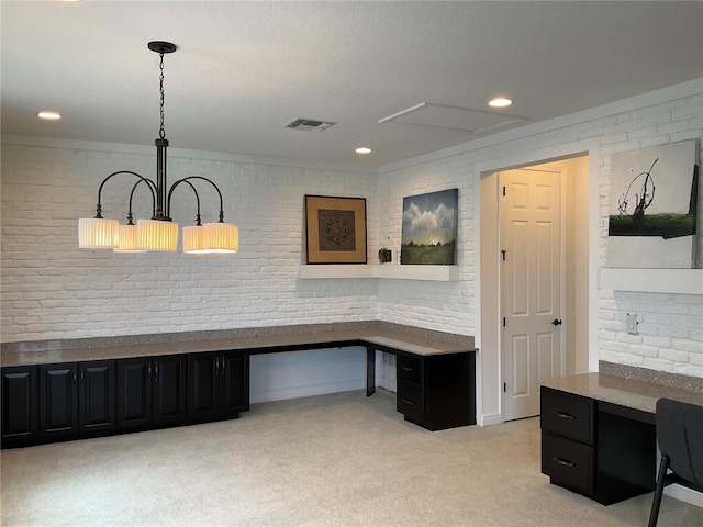 office space with light carpet, ornamental molding, and brick wall