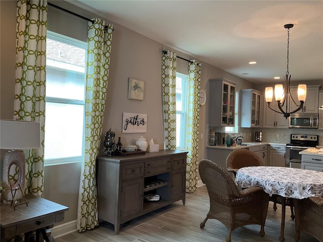 dining room with sink and an inviting chandelier