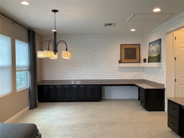 unfurnished office featuring light carpet, brick wall, and ornamental molding