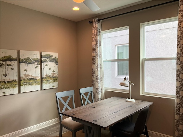 dining room with hardwood / wood-style flooring and ceiling fan