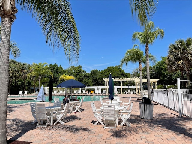 view of swimming pool featuring a pergola and a patio