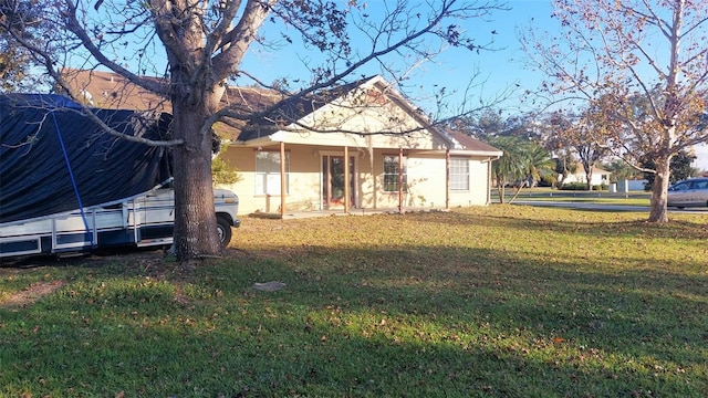 exterior space featuring covered porch and a front yard