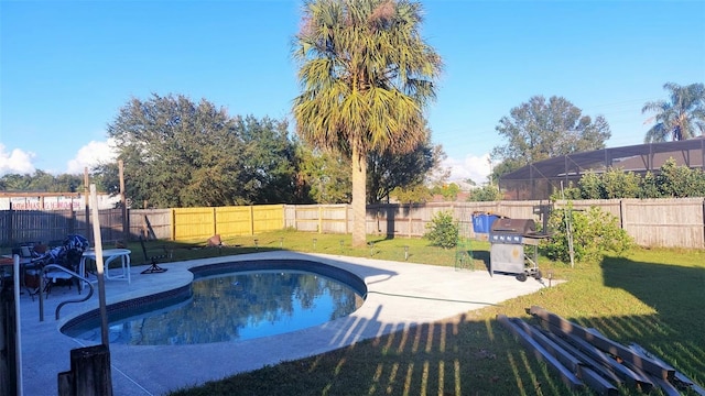 view of swimming pool with area for grilling, a yard, and a patio