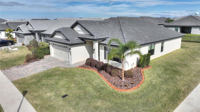 view of front of home with a front yard and a garage