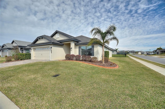 view of front facade with a garage and a front lawn