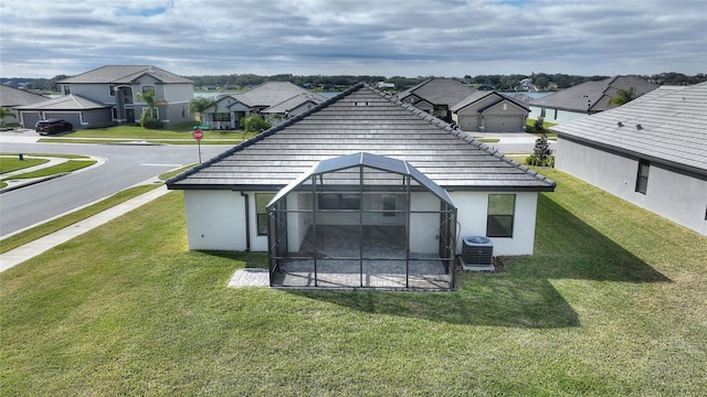 exterior space with cooling unit and a lawn