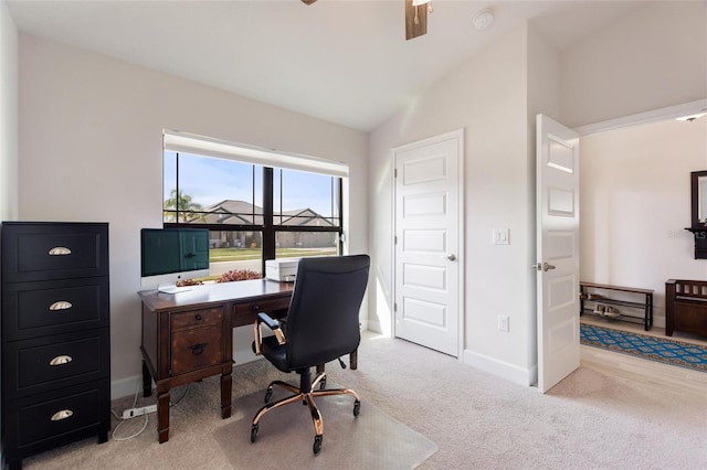 carpeted office space featuring lofted ceiling