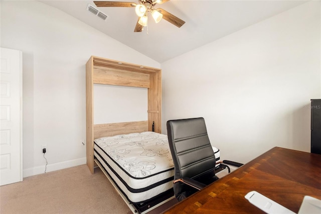 carpeted bedroom with ceiling fan and vaulted ceiling