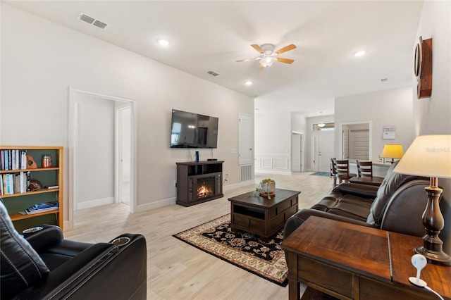 living room with ceiling fan and light hardwood / wood-style floors