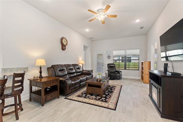 living room with ceiling fan and light hardwood / wood-style floors