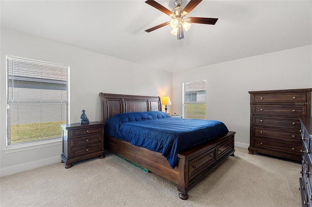 carpeted bedroom with multiple windows and ceiling fan