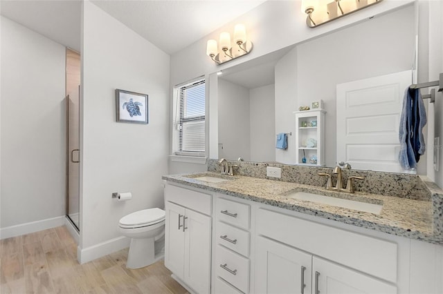 bathroom featuring hardwood / wood-style floors, vanity, toilet, a textured ceiling, and an enclosed shower