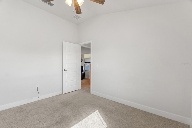 carpeted empty room with ceiling fan and vaulted ceiling