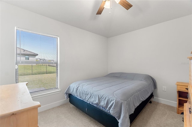 bedroom with light carpet and ceiling fan