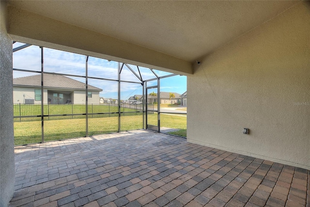 view of patio / terrace featuring glass enclosure