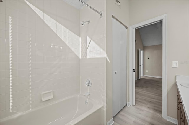 bathroom with vanity,  shower combination, and hardwood / wood-style flooring