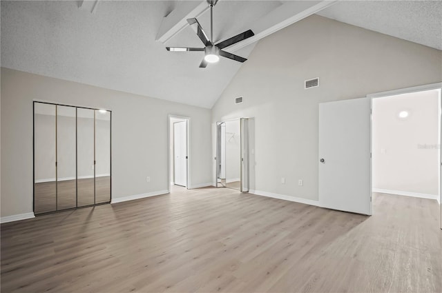 unfurnished bedroom featuring beamed ceiling, light hardwood / wood-style flooring, high vaulted ceiling, and ceiling fan