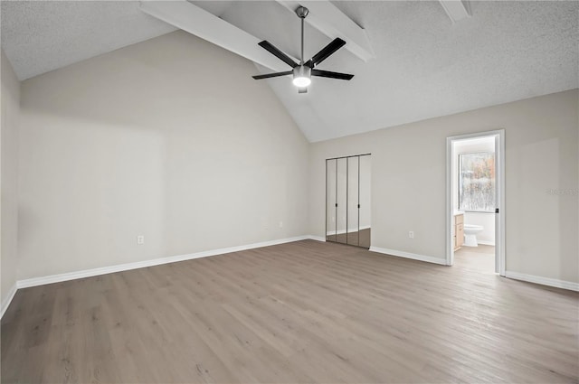 interior space with wood-type flooring, a textured ceiling, high vaulted ceiling, and ceiling fan