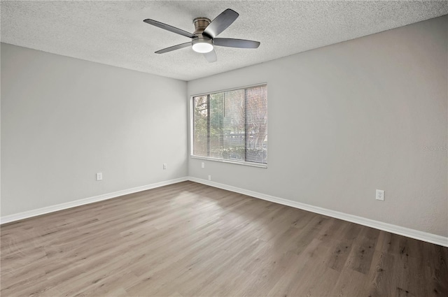 empty room with ceiling fan, a textured ceiling, and light hardwood / wood-style flooring