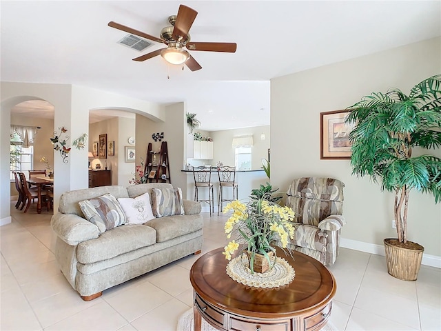 living room featuring ceiling fan and light tile patterned floors