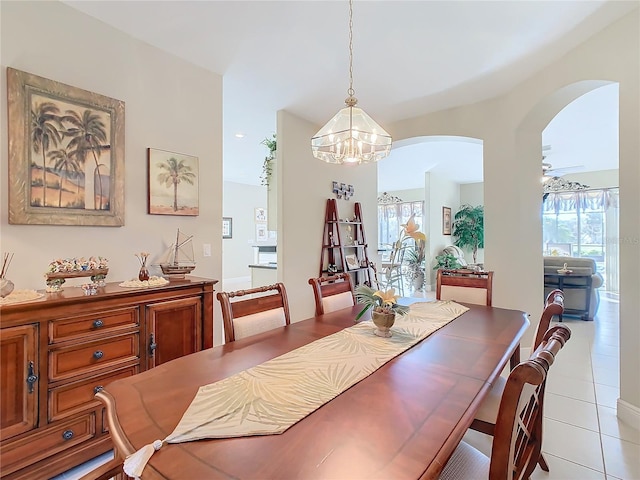 tiled dining room with a notable chandelier