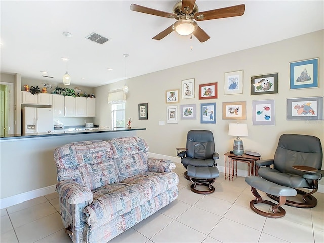 living room featuring ceiling fan and light tile patterned floors