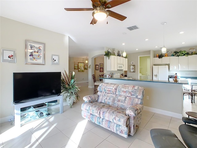 tiled living room featuring ceiling fan