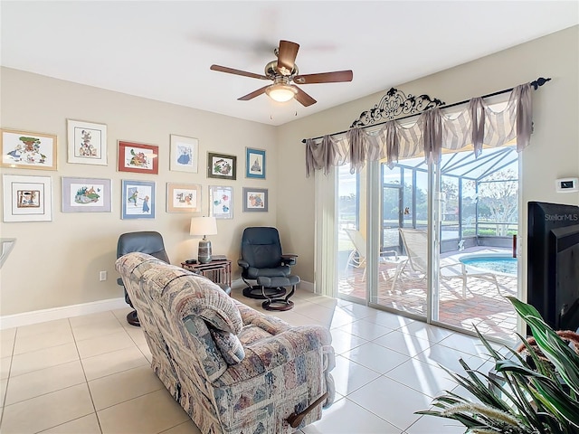 living room with ceiling fan and light tile patterned flooring