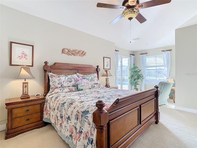 bedroom with ceiling fan and light carpet