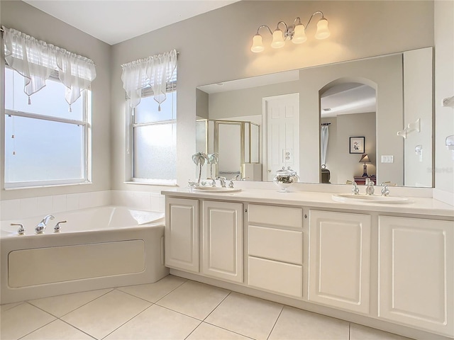 bathroom featuring vanity, tile patterned floors, and shower with separate bathtub