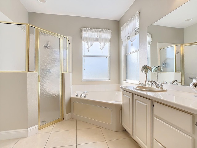 bathroom with tile patterned flooring, shower with separate bathtub, and vanity