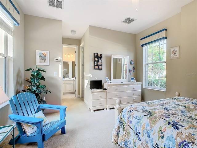 carpeted bedroom with ceiling fan and ensuite bathroom