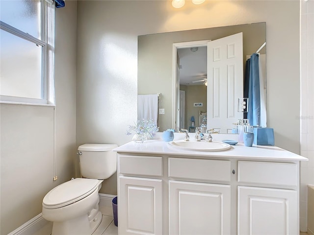 bathroom featuring toilet, ceiling fan, tile patterned floors, vanity, and curtained shower