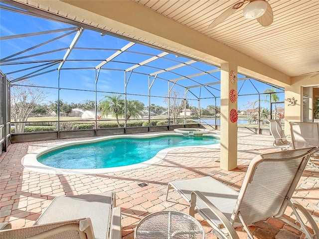 view of pool with a lanai, an in ground hot tub, and a patio