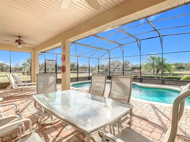 view of patio / terrace featuring glass enclosure and ceiling fan